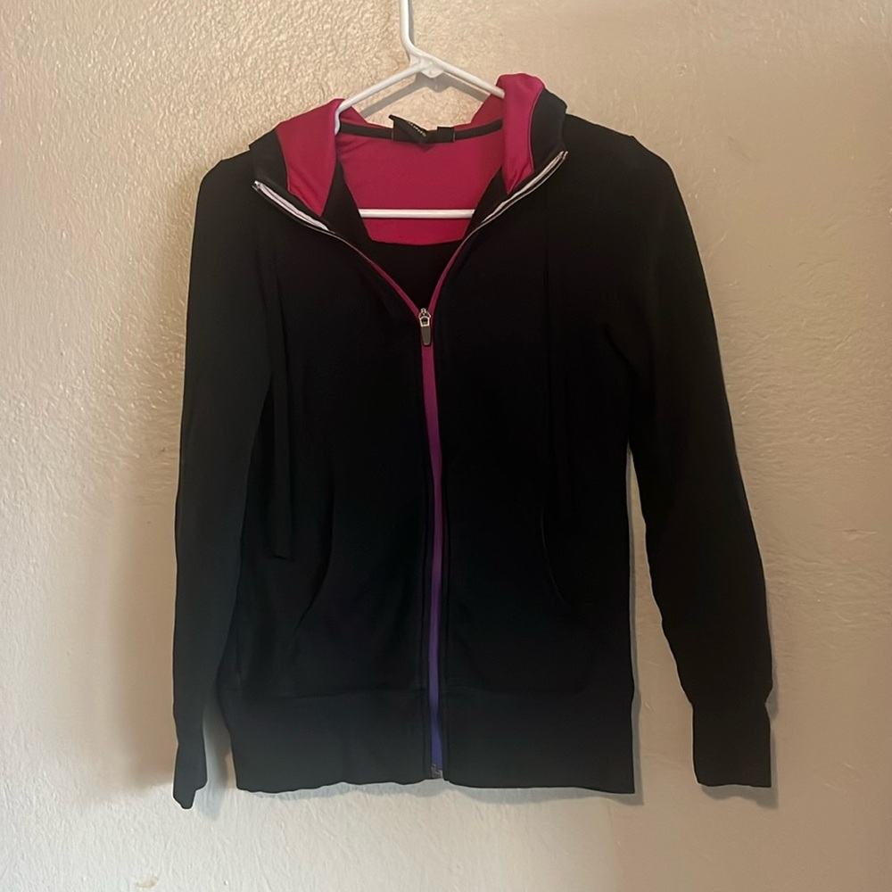 Black hoodie with a magenta zipper and hot pink hood
